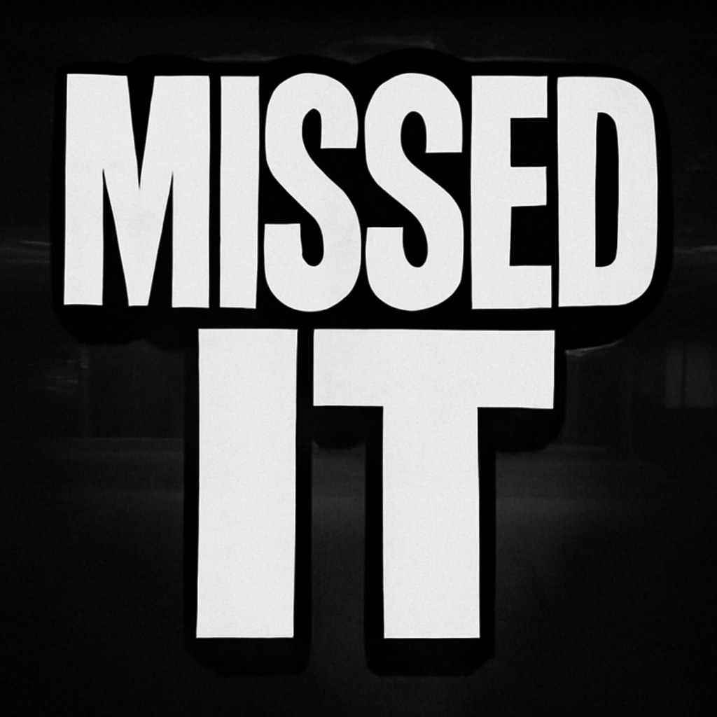 The words MISSED IT set in crammed heavy white letters with a black outline and a shadow cast the wrong way, over a dark empty event hall with the house lights switched off. No character in frame.